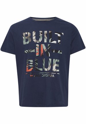 Navy blue cotton t-shirt featuring large graphic text "BUILT IN BLUE" in multicolored foliage patterns. Short sleeves and round neckline.