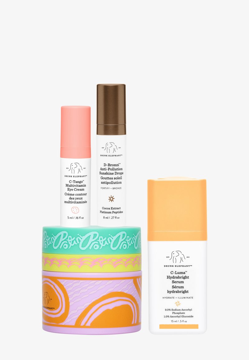 Three Drunk Elephant skincare products: multivitamin eye cream, anti-pollution sunshine drops, and hydrating brightening serum with colorful packaging.
