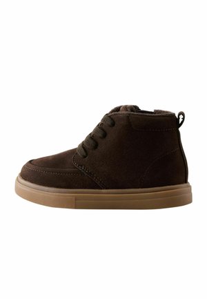 Dark brown suede ankle boot with black laces, thick light brown rubber sole, and pull tab at the heel.