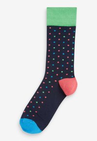 Marineblauer Socke mit grünem Bund, pinker Ferse und blauer Spitze, verziert mit einem Muster aus kleinen roten, grünen und blauen Punkten.