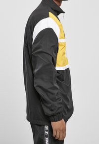Starter Cortaviento - black