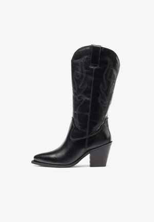 Black leather cowboy boots with a pointed toe and a stacked heel, featuring decorative stitching along the shaft and a tall design.