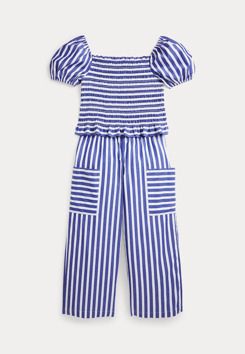 Sinine ja valge triibuline jumpsuit puffvarrukatega, sirge ja pingutatud kehaga ning laia säärega püksid, millel on kaks suurt taskut.