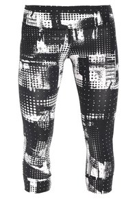 Černobílé legíny s mixem vzorů, včetně teček a abstraktních tvarů, vyrobené z hladkého a pružného materiálu.