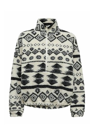 Fleece pullover met hoge kraag, voorzien van een halve ritssluiting. Crème achtergrond met zwarte geometrische patronen en een textuurafwerking.
