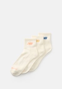 Trois paires de chaussettes de cheville couleur crème avec des bords côtelés, chacune arborant un logo "NB" de couleur différente en rose, jaune et bleu.