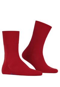 Red cotton socks with a ribbed cuff and smooth texture. Notable for the blue accent near the toe and contoured fit.