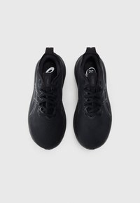 Black athletic shoes with a textured mesh upper, lacing system, and a curved sole. Features subtle branding and a smooth finish.