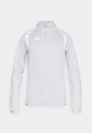 White long-sleeve pullover shirt with a high collar and half-zipper. Features side stripes and an embroidered logo on the chest. Smooth texture.
