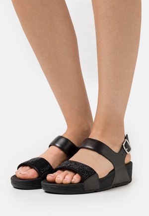 Zwarte sandalen met een gestructureerde bovenband met rhinestones, een soepele leren onderband en een gesp-sluiting op een sleehak.