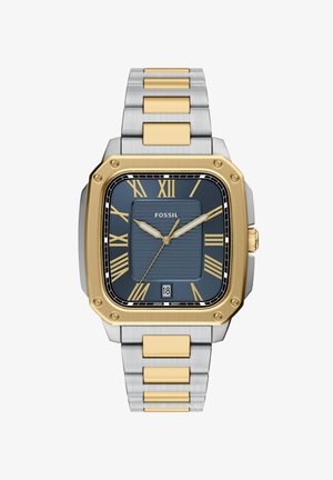 Vierkant Fossil-horloge met een blauw gestructureerd wijzerplaat, gouden uurmarkeringen en datumweergave. De metalen armband heeft zilveren en gouden accenten.