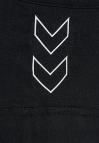 Two white outlined downward chevrons printed on black textured fabric near a seam.
