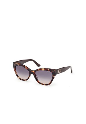 Lunettes de soleil en écaille de tortue avec verres dégradés, monture brune audacieuse, accent logo sur la branche, finition lisse.