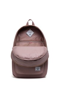 Zaino in tessuto mauve con forma arrotondata. Cerniera a vista e tasca frontale con etichetta Herschel. L'interno presenta una fodera a righe.