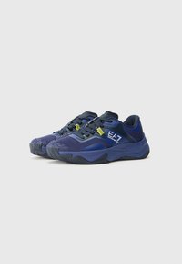 Blue athletic shoes with a textured mesh upper, padded collar, and flexible rubber sole. Features logo and contrasting yellow accents.