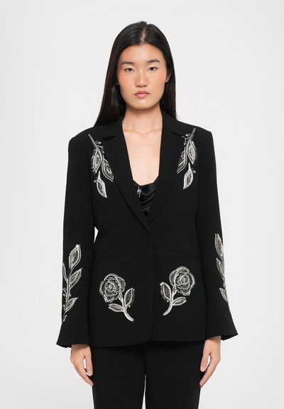 Black blazer with silver floral embroidery on sleeves and pockets, featuring a notched collar and two front pockets. Smooth fabric texture.