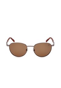 Occhiali da sole ovali di colore marrone con montatura metallica sottile, bracci a tartaruga marrone e cuscinetti nasali trasparenti, caratterizzati da un design minimale.