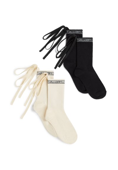 Deux paires de chaussettes côtelées en noir et crème, chacune avec de longs rubans assortis et le logo "KARLLAGERFELD" sur les poignets.