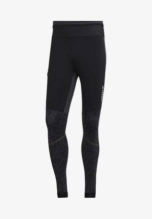 Sorte atletiske leggings med en glat tekstur, der har et mønstret nederste ben, en bred talje og refleksbranding på siden.