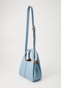 Light blue leather handbag with a rounded shape, dual handles, adjustable strap, and gold-tone hardware. Smooth texture, minimal stitching.