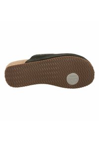 Black slide sandal with a textured upper, cork footbed, and a brown rubber sole featuring a herringbone pattern and logo detail.