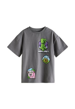 Graues Baumwoll-T-Shirt mit kurzen Ärmeln und Minecraft-Motiven: eine grüne Figur, ein rosa Schaf und eine Biene, alle in farbigen sechseckigen Patches.