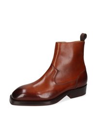 Stivale alla caviglia in pelle marrone con finitura liscia, punta arrotondata, pannelli laterali elastici e una piccola linguetta sul retro. Suola in pelle resistente.