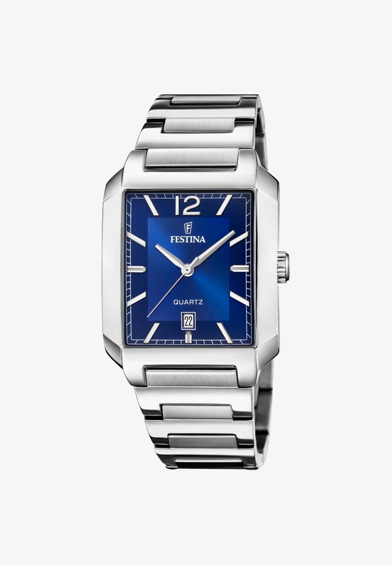 Sudraba nerūsējošā tērauda pulksteņi ar kvadrātu zilā ciparnīcā, baltas stundu marķējumi, datuma rādītājs un metāla saite. Iekļauta kvartāla kustība.