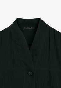 Black textured jacket featuring a deep V-neck and a single button closure. Label reads "Massimo Dutti."
