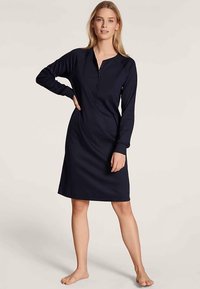 Navy blue long-sleeve dress made of soft fabric, featuring a henley neckline with buttons and a relaxed fit, knee-length design.