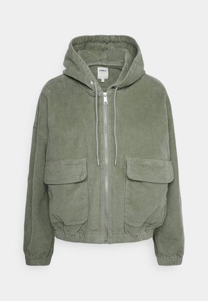 Green corduroy hooded jacket with a zip front, two large front pockets, and elasticated cuffs and hem. Textured fabric with vertical stripes.