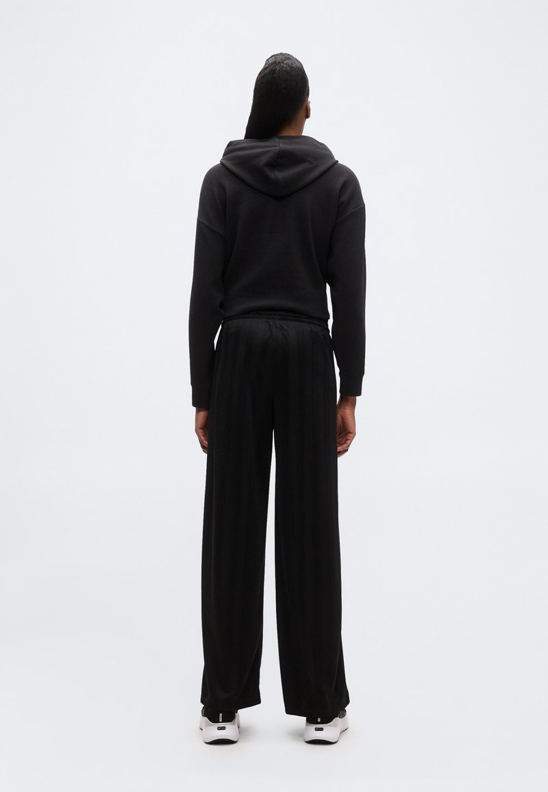 Puma LEAGUE WIDE LEG - Teplákové kalhoty - black