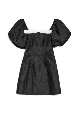 Vestido negro con mangas abullonadas, tela texturizada, corsé ajustado y un detalle de cinta blanca de satén en la parte trasera. Largo corto.