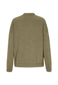 Olivgrön kviltad jacka med ett blommigt upphöjt mönster, rund halsringning och långa ärmar, med en avslappnad passform och elastisk nederkant.
