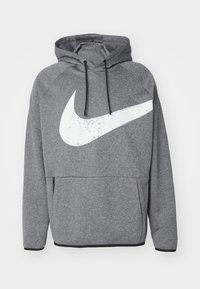 Sweat à capuche gris avec un grand logo Nike blanc usé, manches raglan, cordons et une poche avant avec détail de fermeture éclair.