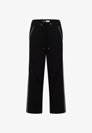 Czarne dresy o luźnym kroju, z elastycznym paskiem na sznurki, bocznymi kieszeniami i białymi paskami na bokach dla uwydatnienia. Miękka tekstura materiału.