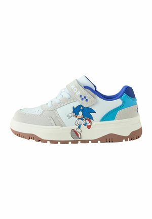 White and blue sneakers featuring a gray suede accent. Includes a Sonic character graphic on the side and a Velcro strap for closure.