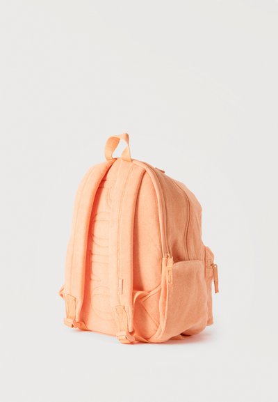 Απαλό ροδακινί σακίδιο πλάτης με μαξιλαρωμένους ιμάντες ώμου, επάνω λαβή, πλαϊνές θήκες και ορατά φερμουάρ κλεισίματος.