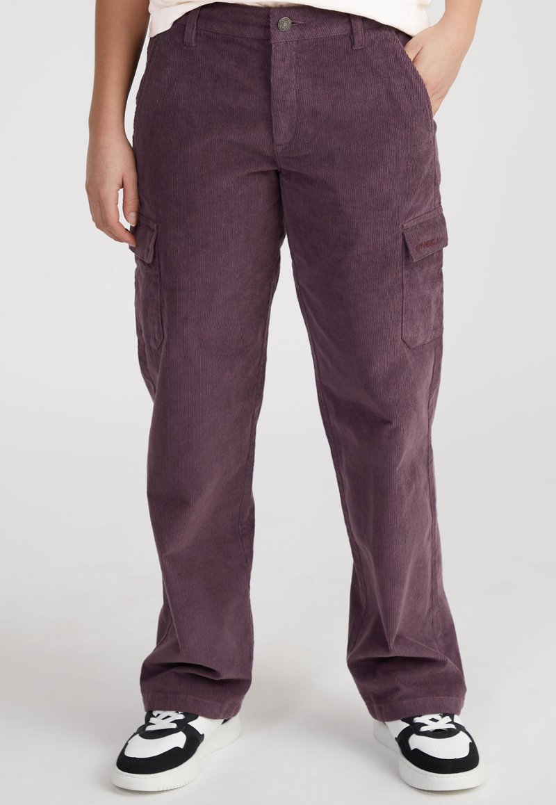 Purple corduroy cargo pants feature a relaxed fit, two side pockets, and a front button closure. Worn with black and white sneakers.