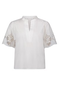 Blusa di cotone bianca con maniche a palloncino corte, caratterizzata da ricami floreali sulle maniche e una scollatura a V.