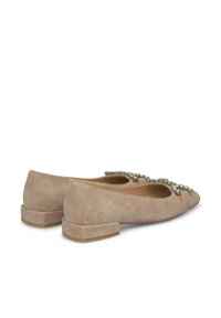 Bailarinas de ante beige con puntera afilada y tacón cuadrado bajo, que presentan un adorno decorativo de cuentas en la parte delantera.