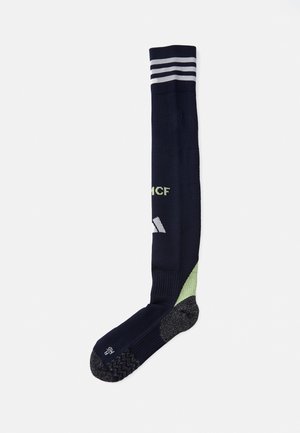 Chaussettes jusqu'au genou navy avec des accents gris et vert clair, bord côtelé, semelle texturée et détail de logo ; dotées d'un rembourrage renforcé au niveau du pied et d'un soutien de la voûte plantaire.