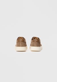 Pair of brown suede sneakers with white soles shown from the back on a plain white background.