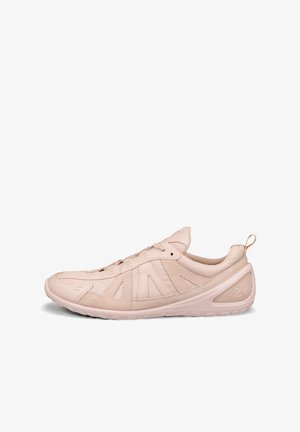 Light pink low-top athletic shoe with lace-up closure, textured sole, and pull tab at heel, shown in side profile.