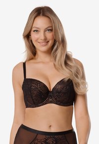 Czarny biustonosz z koronką i fiszbinami, z kwiatowym wzorem, w kształcie litery V i regulowanymi ramiączkami. Złote akcenty w środkowej części.