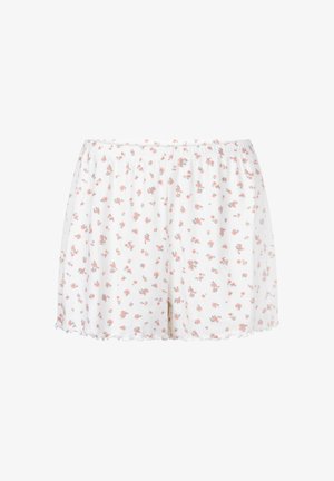 Witte shorts met elastische tailleband, voorzien van een klein roze bloemenpatroon en een golvende rand.