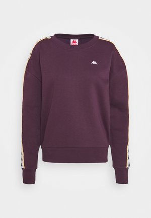 Paarse lange mouw sweatshirt met wit en zwart logo op de mouwen en een klein wit logo op de bovenste borst, geribbelde manchetten en zoom.