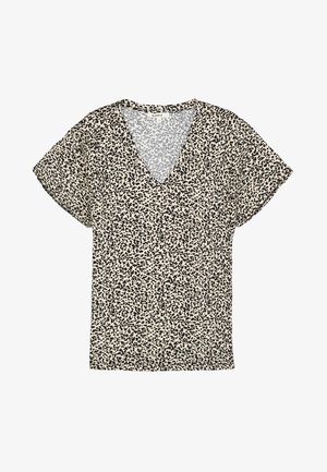 Blouse manches courtes à col en V, base beige avec de petites taches noires irrégulières sur tout le tissu.