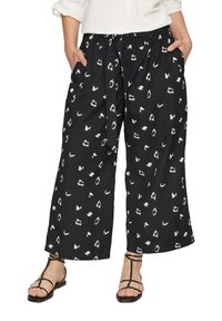 Zwarte wijde broek met een wit abstract patroon, met een elastische tailleband en strikdetail, gemaakt van lichte stof.