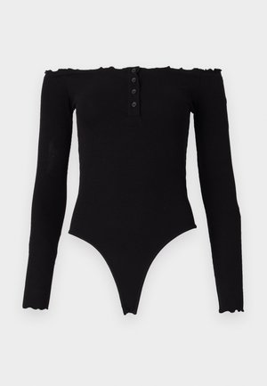 Bodysuit negro con escote en los hombros y mangas largas, textura acanalada, tapeta de botones y bordes con ondas. Diseñado con una pierna de corte alto.